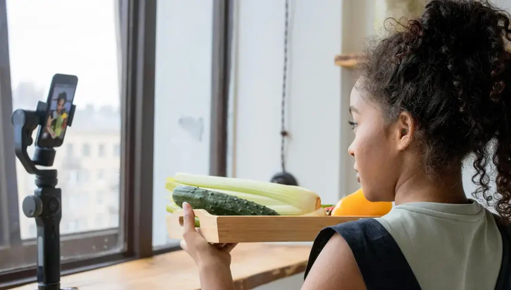 Creator filming a vertical video on smartphone.